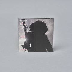 Album cover featuring a silhouette of a person with a hat against a light background.