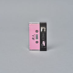 Pink and black audio cassette tape with visible text and graphics on the labels.