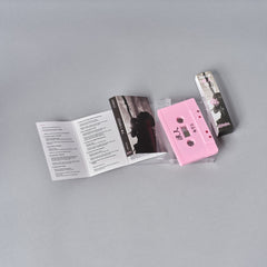 Pink audio cassette tape with accompanying lyric booklet and case.