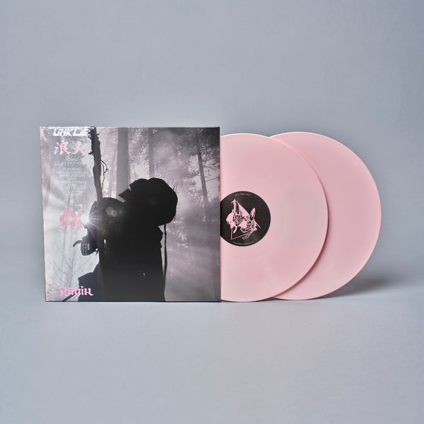 Pink vinyl record album with a moody black and white forest scene on the cover.