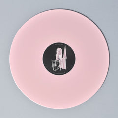 Pink vinyl record with a black label featuring a minimalist cityscape design.