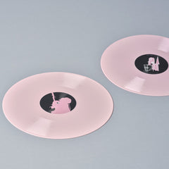 Pink vinyl records with black center labels.