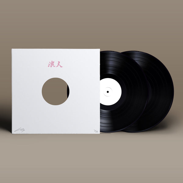 Vinyl record partially inside a white sleeve with Japanese characters.